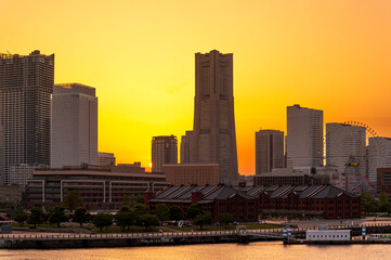 Fototapeta premium sweet gold sunset winter and light illumination from Cityscape of Yokohama city, Skyline and office building and downtown in Minatomirai Area, Yokohama city port, Kanagawa, Japan