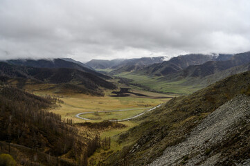Chike-Taman pass in Altai mountains. Mountain landscape in the Altai Republic, Autumn mountains with green and yellow trees. Autumn landscape