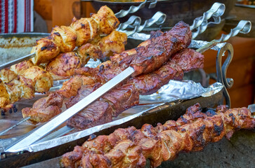 Barbecue grilled meat stick kebab on fire flame with hot charcoal cooking outside