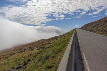 A view from a road of clouds covering a valley of Mageroya Island, Norway