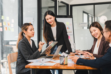 Collaborative business meeting with professionals discussing strategies and ideas. team is engaged, showcasing teamwork and productivity in modern office setting