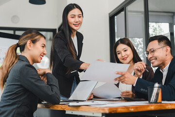 Collaborative business meeting with professionals discussing documents. atmosphere is engaging and productive, showcasing teamwork and communication
