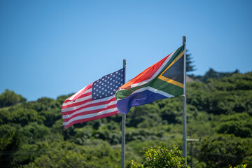 Flags of America and South Africa on pole