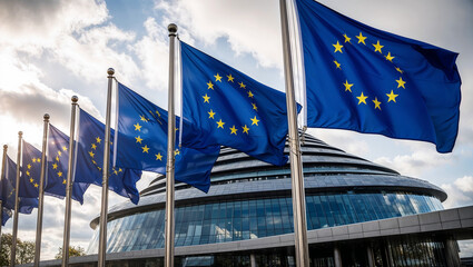European Union flags waving proudly outside a modern building.