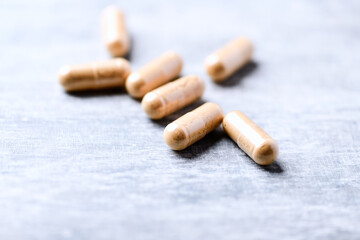 Korean Ginseng capsules. Concept for a healthy dietary supplementation. Wooden background. Soft focus. Close up.