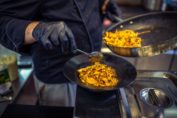 Delicious looking pasta with chicken, vegetables and sauce cooked in the restaurant.