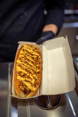 Pulled pork sandwich with mustard made in restaurant.