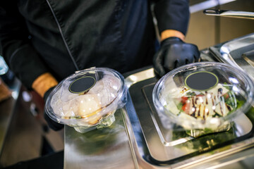 Healthy organic salad packed in a plastic container.