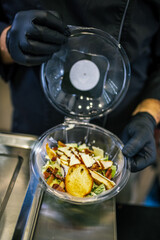 Healthy organic salad packed in a plastic container.