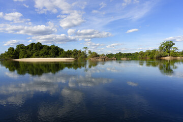 Sky and trees reflecting in the Juruena river, Alta Floresta, Amazon, Brazil