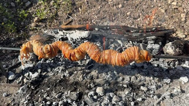 Sa Cordula or sa corda or braided lamb innards cooked on the grill, a typical Sardinian dish
