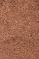 Vertical Brown texture of wall of rural Indian house made from clay mixed with cow dung.