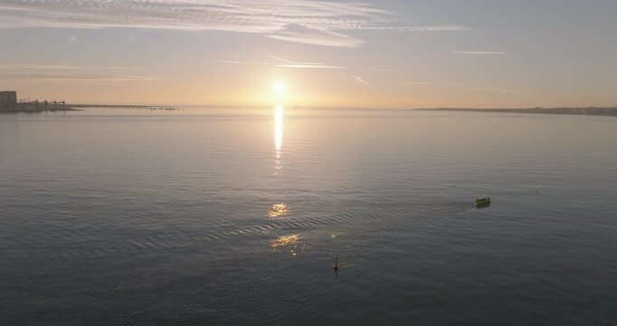 Aerial drone shot of the Forte do Bugio lighthouse, Tagus river, Atlantic Ocean and horizon at sunset from Lisbon, Portugal, Europe. Shot in ProRes 422 HQ