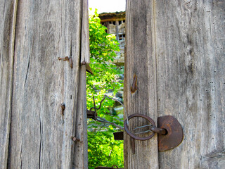 Very old wooden portal gate to farm buildings, detailed abstract view in the Bulgarian Fore-Balkan village of Debnevo, Troyan Municipality, selective focus
