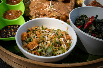 Ingkung Ayam and Terancam, a traditional food from Yogyakarta, Indonesia, made from a whole chicken boiled with spice and cocon            ut milk
