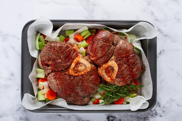 fried meat on the bone, raw, chopped vegetables, ingredients in the oven, for cooking ossobuco, top view, no people,