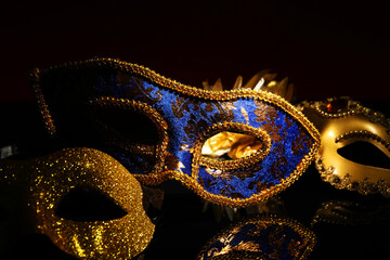 Beautiful blue carnival mask on black background, closeup