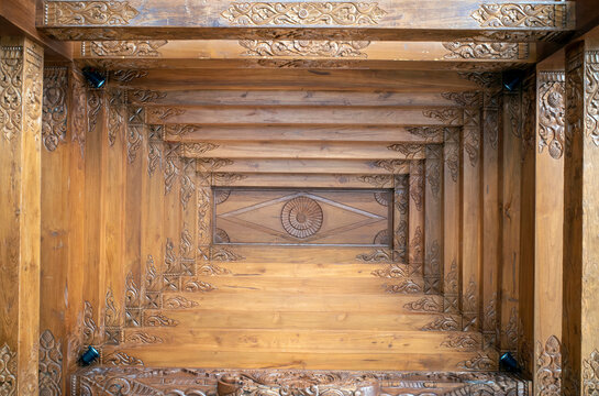 The ceiling of a joglo house, a traditional Javanese house, Indonesia, made of high grade teak wood and handmade carvings