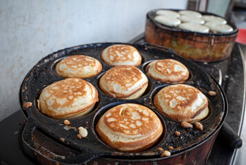 The process of cooking Kue Apem, an Indonesian traditional cake on street food market, in Yogyakarta, Indonesia