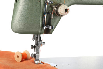 Sewing machine with orange fabric and spool of thread isolated on white
