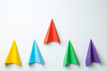 Handmade color paper planes on white background, flat lay