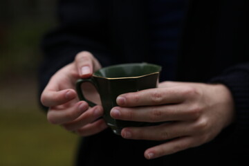 person holding a cup of tea