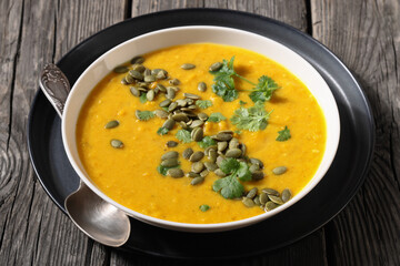 Pumpkin Red Lentil Soup in white bowl, top view