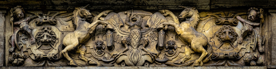 Medieval stone panel with unicorns and royal coat of arms