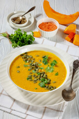 Pumpkin Red Lentil Soup in white bowl, top view