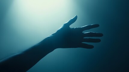 A silhouetted hand reaching out in soft blue light, creating a serene atmosphere.