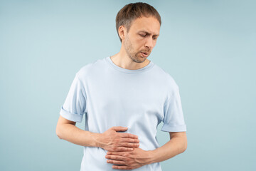 Unhealthy man with gastrointestinal problems with stomach pain, bloating, cramps, sharp aches....