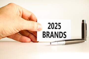 Planning 2025 brands new year symbol. Concept words 2025 Brands on beautiful white card. Beautiful white background. Businessman hand. Business 2025 brands new year concept. Copy space.