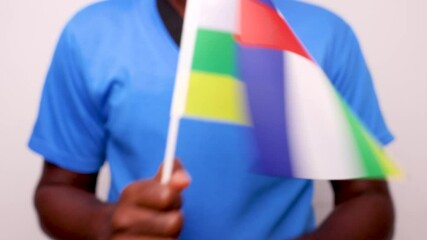 Excited Black African man dancing and waving Central African Republic flag over white background. - Powered by Adobe