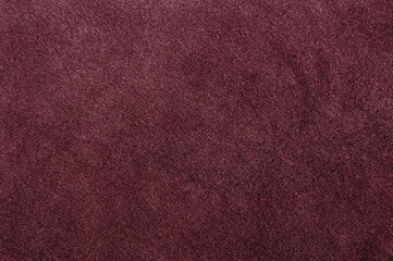 Close-up of rich burgundy velour texture, showcasing a smooth and soft fabric surface.