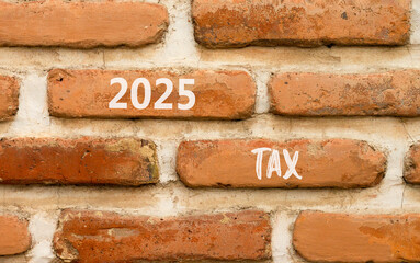 Planning 2025 tax new year symbol. Concept words 2025 Tax on beautiful brown brick wall. Beautiful brown brick wall background. Business 2025 tax new year concept. Copy space.