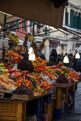 Fruit and vegetable stall in a street market in Venice. Late afternoon in December.