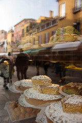 Reflections of Venice in a cake shop, patisserie window.