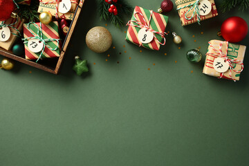 Xmas gift boxes wrapped vintage paper with advent calendar tags and festive ornaments on green background. Flat lay, top view