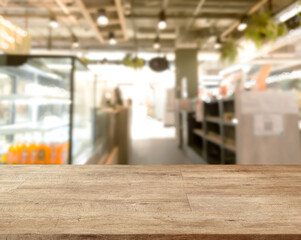 Wooden board empty table in front blurred bakery and coffee shop abstract background, Brown tones warm mood used component for making posters or product brochures.