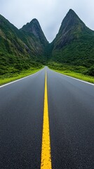 A scenic country road stretches toward majestic mountains under a bright blue sky with fluffy clouds inviting adventure and exploration