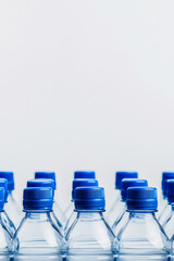 A row of plastic bottles with blue caps