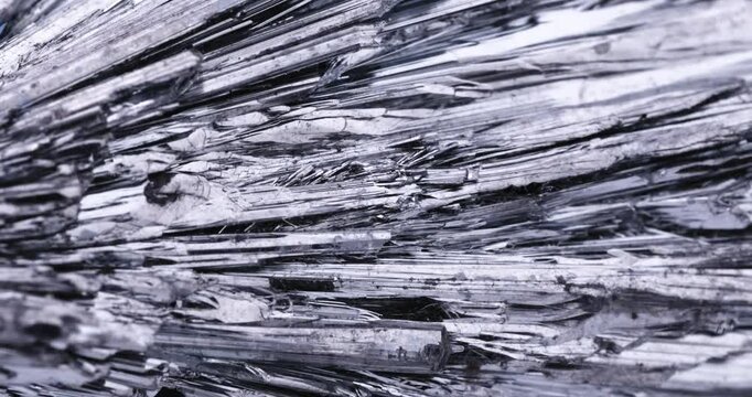 Stibnite crystals. rotating footage. Specimen from Potos&iacute; Mine, Francisco Portillo, Mexico. macro detail close-up mineral crystal unpolished semi-precious gemstone.