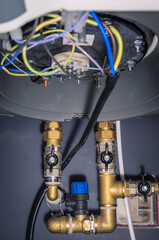 Connecting an electric water heater to water and electricity
