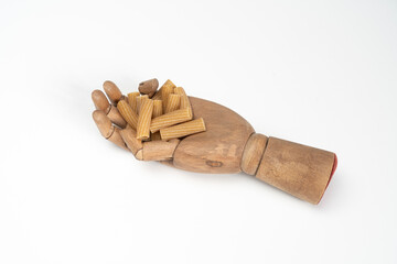 rigatoni pasta in wooden hand