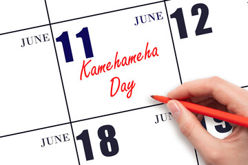 June 11. Hand writing text Kamehameha Day on calendar date. Save the date.