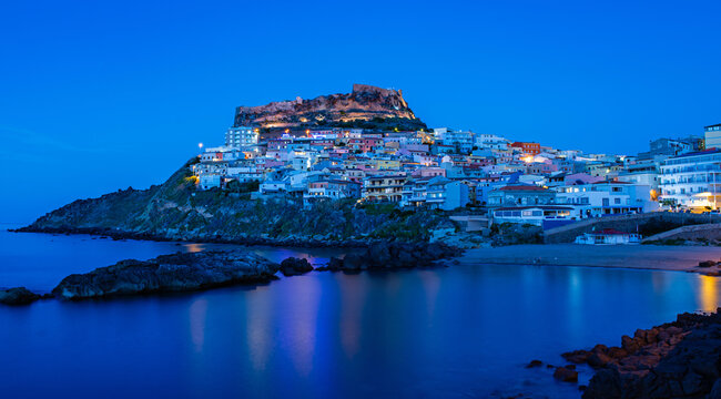 Picturesque panoramic view of medieval town of Castelsardo at night, during the blue hour, Province of Sassari, Sardinia, Italy, Europe.