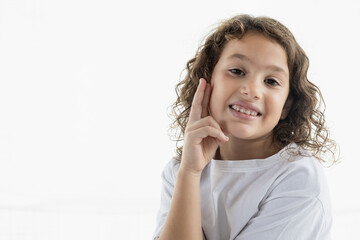 Playful portrait of a 7-year-old girl with a quirky expression