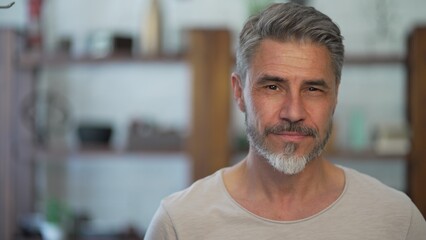 Portrait of happy, confident older man at home looking at camera smiling. Mature age, middle age,...