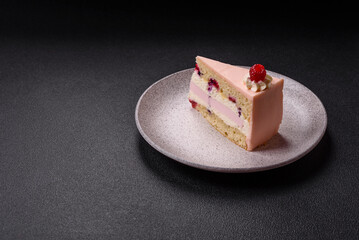 Piece of sweet cake with pink cream with raspberry flavor, with shortbread, cheesecake