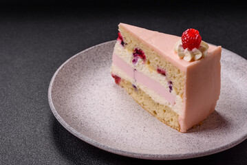 Piece of sweet cake with pink cream with raspberry flavor, with shortbread, cheesecake